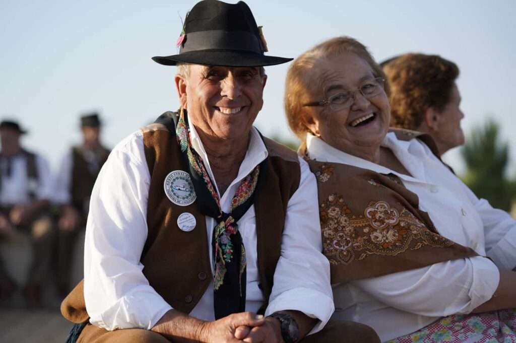 Smiling older man and woman in traditional folk costume